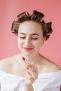 Closeup portrait of beautiful girl putting on red lipstick Royalty Free Stock Photo