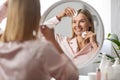 Beautiful Middle Aged Woman Cleansing Skin With Cotton Pad Near Mirror Royalty Free Stock Photo