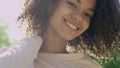 Closeup portrait of a beautiful mixed race woman smiling warmly to a camera.