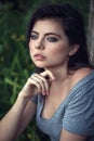 Closeup portrait of beautiful young Caucasian woman with black hair, blue eyes, looking away Royalty Free Stock Photo