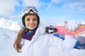 Closeup portrait of beautiful skier girl wearing mask and holding ski, enjoying winter holidays