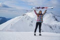 Closeup portrait of beautiful skier girl wearing mask and holding ski, enjoying winter holidays