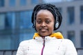 African american young woman listening music on wireless headphones outdoor Royalty Free Stock Photo