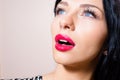 Closeup portrait of beautiful tempting brunette young woman with blue eyes, long lashes, red lipstick looking up Royalty Free Stock Photo