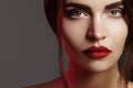 Closeup portrait with of beautiful woman face. Red color of fashion lip makeup, clean shiny skin and strong eyebrows Royalty Free Stock Photo