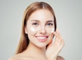 Closeup portrait of beautiful woman with healthy face and skiHealthy woman face. Cute girl with clear skin applying cream Royalty Free Stock Photo