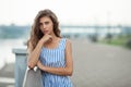 Closeup portrait of beautiful woman in summer dress posing in city river park pier enjoying weekend. Playful and beautiful Royalty Free Stock Photo