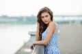 Closeup portrait of beautiful woman in summer dress posing in city river park pier enjoying weekend. Playful and beautiful Royalty Free Stock Photo