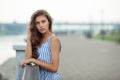 Closeup portrait of beautiful woman in summer dress posing in city river park pier enjoying weekend. Playful and beautiful Royalty Free Stock Photo