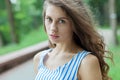 Closeup portrait of beautiful woman in summer dress posing in green park enjoying weekend. Playful and beautiful caucasian girl on Royalty Free Stock Photo