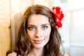 Closeup portrait of beautiful young blue eyes lady with shadow from window blinds on light copy space background