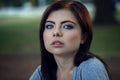 Closeup portrait of beautiful young Caucasian woman with black hair, blue eyes, looking in camera Royalty Free Stock Photo