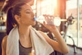 Closeup portrait of beautiful young fit woman drinking water during traning in the gym. Royalty Free Stock Photo