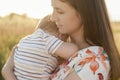 Closeup portrait of beautiful young mother holding her baby son in hands Royalty Free Stock Photo