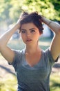 Closeup portrait of beautiful young Caucasian woman with red black hair, blue eyes, looking in camera Royalty Free Stock Photo