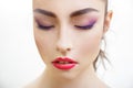 Closeup portrait of beautiful young woman with bright purple makeup and fuchsia lips Royalty Free Stock Photo