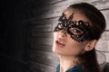 Closeup portrait of beautiful young woman in elegant masquerade mask on the eyes