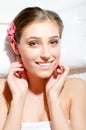 Closeup portrait of beautiful young woman during spa treatments happy smiling & looking at camera on white Royalty Free Stock Photo