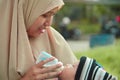 Closeup portrait of beautifull baby boy drinking milk from his mother from feeding bottle Royalty Free Stock Photo