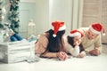 Family in Christmas Santa hats lying on bed. Mother father and baby having fun Royalty Free Stock Photo