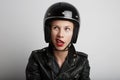 Closeup portrait of biker woman over white background, wearing stylish black sportive helmet and leather jacket. Royalty Free Stock Photo