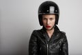 Closeup portrait of biker woman over white background, wearing stylish black sportive helmet and leather jacket. Royalty Free Stock Photo