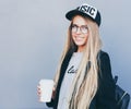 Closeup portrait of blonde girl with long haircut. Hipster, insagram style. She wears black trendy dress, glasses Royalty Free Stock Photo