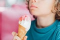 Closeup portrait of boy eating cone ice cream. Child licking ice cream. Royalty Free Stock Photo