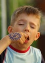 Closeup portrait of a boy eating crisps with eyes closed Royalty Free Stock Photo