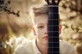 Closeup Portrait boy with guitar in summer day. Royalty Free Stock Photo