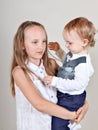 Closeup portrait of a brother and sister. little boy hugging his older sister. Royalty Free Stock Photo