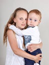 Closeup portrait of a brother and sister. little boy hugging his older sister. Royalty Free Stock Photo