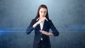 Closeup portrait business woman raising hands in the air attack with karate chop, isolated blue background.