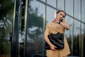 Closeup Portrait of an businesswoman standing outside office building and speaking mobile phone Royalty Free Stock Photo