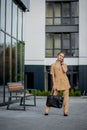 Closeup Portrait of an businesswoman standing outside office building and speaking mobile phone Royalty Free Stock Photo