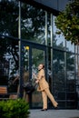 Closeup Portrait of an businesswoman standing outside office building and speaking mobile phone Royalty Free Stock Photo