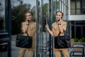 Closeup Portrait of an businesswoman standing outside office building and speaking mobile phone Royalty Free Stock Photo