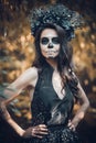 Closeup portrait of Calavera Catrina in black dress. Sugar skull makeup. Dia de los muertos. Day of The Dead. Halloween