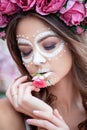 Closeup portrait of Calavera Catrina in pink dress. Sugar skull makeup. Dia de los muertos. Day of The Dead. Halloween Royalty Free Stock Photo