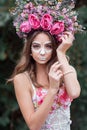 Closeup portrait of Calavera Catrina in pink dress. Sugar skull makeup. Dia de los muertos. Day of The Dead. Halloween