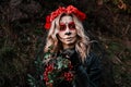 Closeup portrait of Calavera Catrina. Young woman with sugar skull makeup and red flowers. Dia de los muertos. Day of Royalty Free Stock Photo