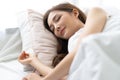 Closeup portrait of a calm young pretty Asian woman sleeping in her bed and relaxing in the morning. Lady enjoying sweet dreams Royalty Free Stock Photo