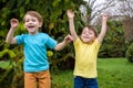 Closeup portrait of Caucasian two little brothers boys laughing outside in park on summer day Royalty Free Stock Photo