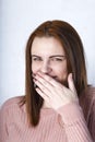 Closeup portrait cheerful girl with beautiful face and attractive amile. Smiling shy woman covering mouth her face with a hand Royalty Free Stock Photo