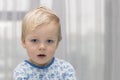 Closeup portrait of child, cute toddler with blue eyes. Copy space