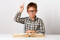 Closeup portrait child with glasses reading book, white background Royalty Free Stock Photo