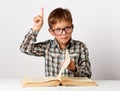 Closeup portrait child with glasses reading book, white background Royalty Free Stock Photo