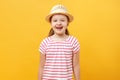 Closeup portrait of a child on a yellow background. Cheerful happy cute beautiful charming little girl in a straw hat and a T- Royalty Free Stock Photo