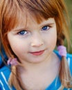 Closeup portrait of cute adorable little red-haired Caucasian girl child with blue eyes Royalty Free Stock Photo