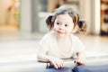 Closeup portrait of cute adorable smiling white Caucasian toddler girl child with dark brown eyes and curly pig-tails